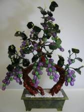 LAVENDER JADE GRAPES TREE (20A-4)
THIS LOVERLY AND BEAUTIFUL JADE GRAPES VINES TREE IS MADE OF REAL JADE THAT IS IN LAVENDER COLOR. IT IS ABSOLUTELY MADE OF NATURAL REAL JADE WHERE THIS TYPE IS CALLED OIL JADE DUE TO ITS SHINING TEXTURE AND LOOK TRANSPARENT LIKE GLASS. THE LEAVES AND POT ARE MADE OF GREEN TAIWAN JADE. IT IS AN IDEAL DECORATION FOR YOUR LIVING ROOM, DINING ROOM, OFFICE AND KITCHEN. 
SIZE: L 16in, H 21in, W 8in.
PRICE  US $ 149.00 + S/H