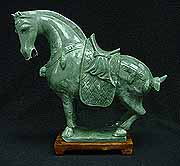 REAL JADE SADDLED HORSE (LH004) This horse is made from one piece solid Taiwan jade. It appears light green with some area dark green. It comes with a wooden base. 
SIZE:L:12 in, W: 4 in, H: 11 in.
Click Here To See Big Picture.