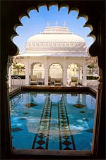 The inviting pool at Lake Palace, Udaipur (must've been tough for the photographer to not jump in straight away!) with Lake Pichhola and City Palace partially visible in the background.